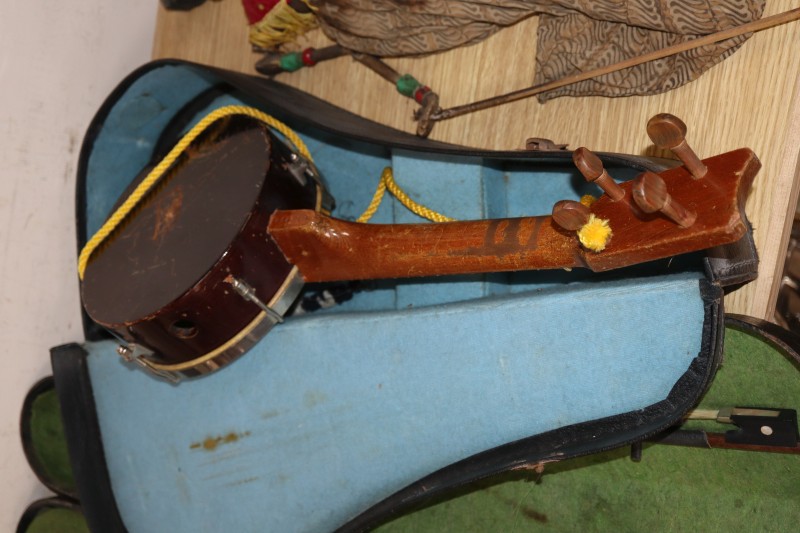 An early 20th century Saxon violin cased with bow and a cased banjo